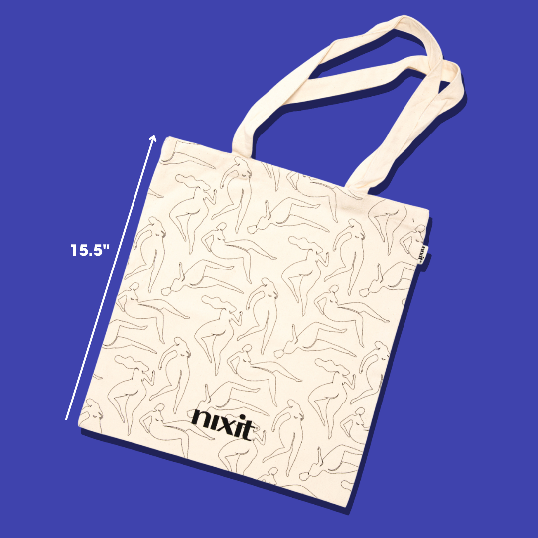 the nixit organic cotton tote bag lies flat on a blue background. A line indicates that the length of the bag is 15.5"