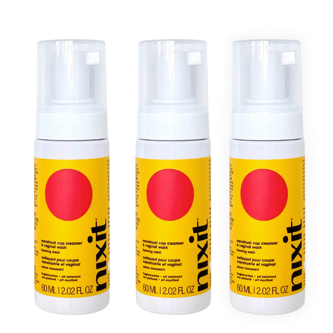 Three bottles of travel size nixit menstrual cup cleanser and vulva wash are side by side